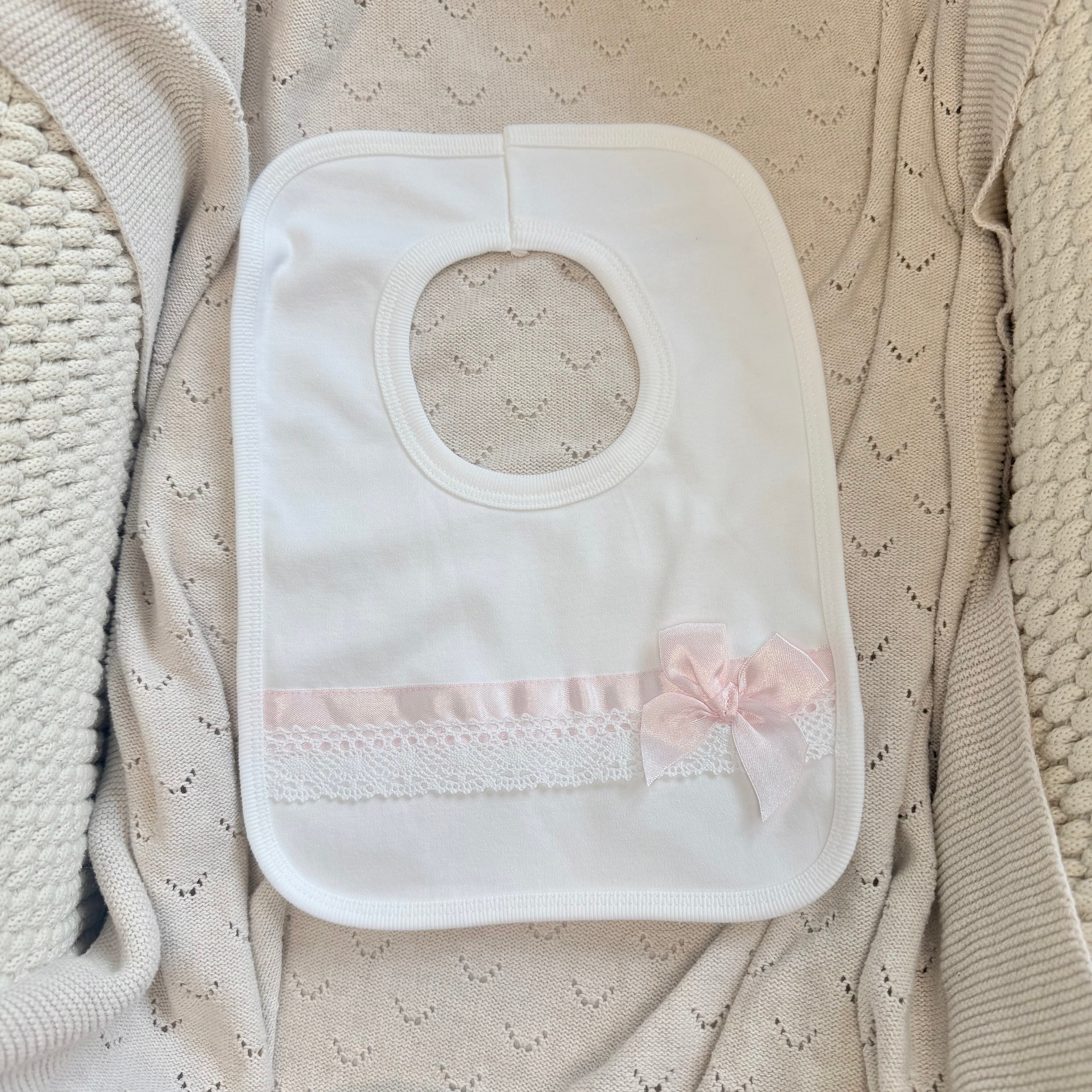 
                  
                    Baby Girls White Bib With Pink Satin Bow & Lace Trim
                  
                